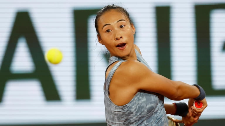 China's Zheng Qinwen plays a shot against France's Alize Cornet...