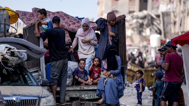 Palestinians displaced by the Israeli air and ground offensive on...