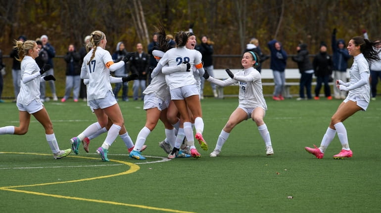 Smithtown West girls soccer celebrates its first goal against Columbia...