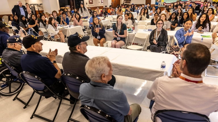 High school students interact with veterans Thursday at the Long...