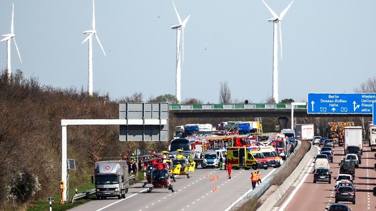 Emergency vehicles and rescue helicopters are seen at the scene...