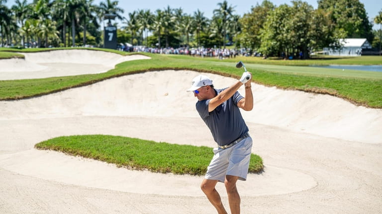 Captain Phil Mickelson, of HyFlyers GC, hits from a bunker...