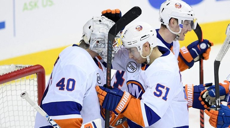 slanders center Valtteri Filppula (51) celebrates with goaltender Robin Lehner...