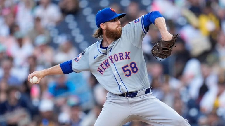 Mets starting pitcher Paul Blackburn works against a Padres batter...