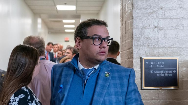 Rep. George Santos, R-N.Y., departs after a Republican caucus meeting at...