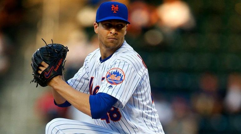 Mets pitcher Jacob deGrom delivers in the first inning against...