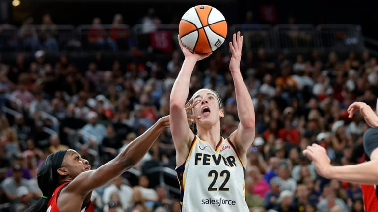 Indiana Fever guard Caitlin Clark (22) is fouled by Las...