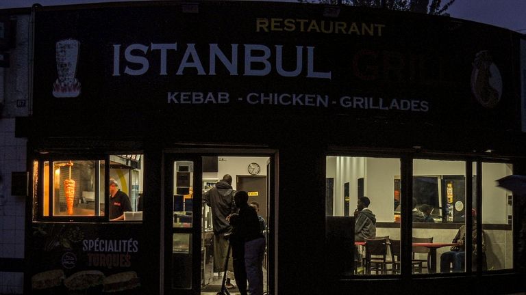 People watch a soccer match in a Turkish restaurant during...