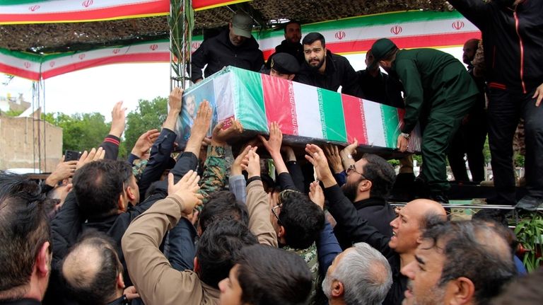 In this photo provided by Fars News Agency, mourners carry...