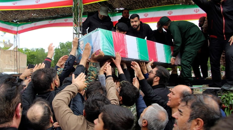 In this photo provided by Fars News Agency, mourners carry...