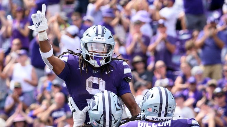 Kansas State running back Treshaun Ward (9) celebrates his touchdown...