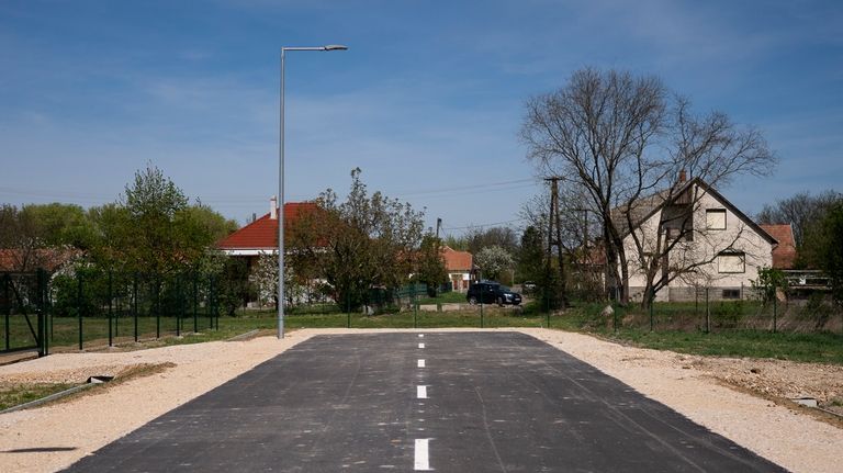 A road leads to nowhere next to an industrial facility...