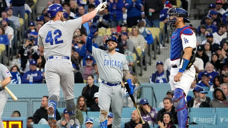 Chicago Cubs' Patrick Wisdom (16) celebrates after hitting a home