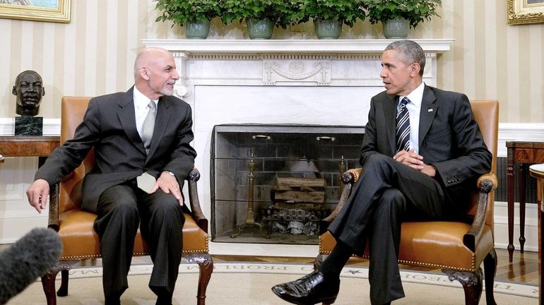 President Barack Obama speaks to Afghan President Ashraf Ghani during...