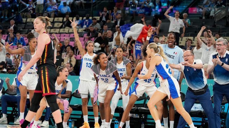 Team France bench reacts after Marine Johannes (23), of France,...