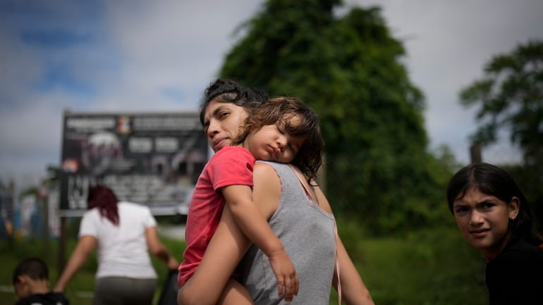 Venezuela migrant Naiber Zerpa holds her son Mathias Marquez as...