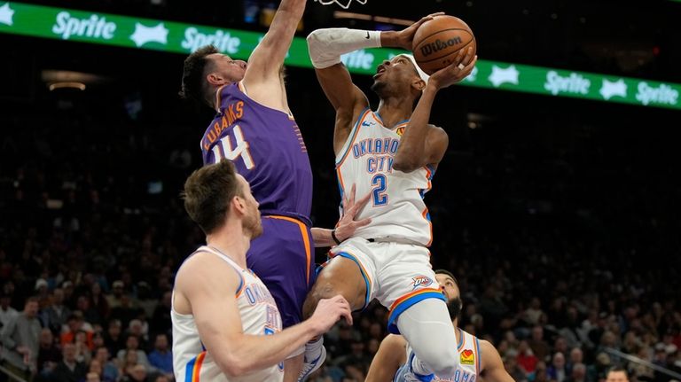 Oklahoma City Thunder guard Shai Gilgeous-Alexander (2) drives against Phoenix...