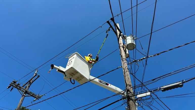 Robert Cowboy Geiser, 39, fixes a power line after widespread...