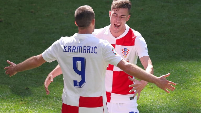 Croatia's scorer Andrej Kramaric, left, and his teammate Luka Sucic,...