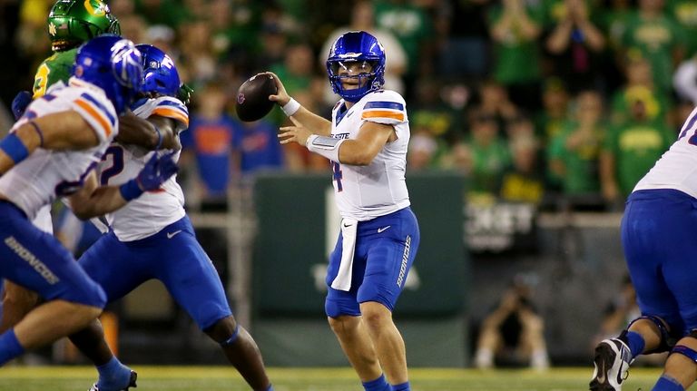 Boise State quarterback Maddux Madsen, center, looks to pass during...