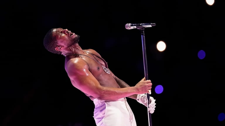 Usher performs during halftime of the NFL Super Bowl 58...