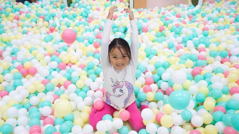 Olivia Suh, 6, of Hicksville, plays at Nana's Wonderland in...