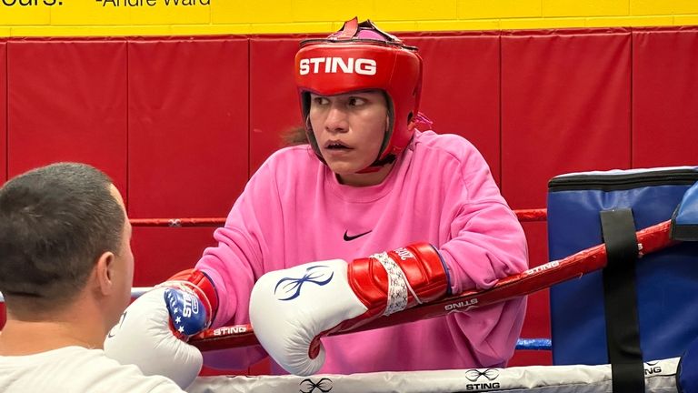 U.S. Olympic lightweight Jajaira Gonzalez listens to coach Tim Nolan...