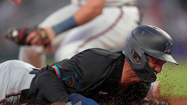 Miami Marlins' Forrest Wall is safe at third base on...