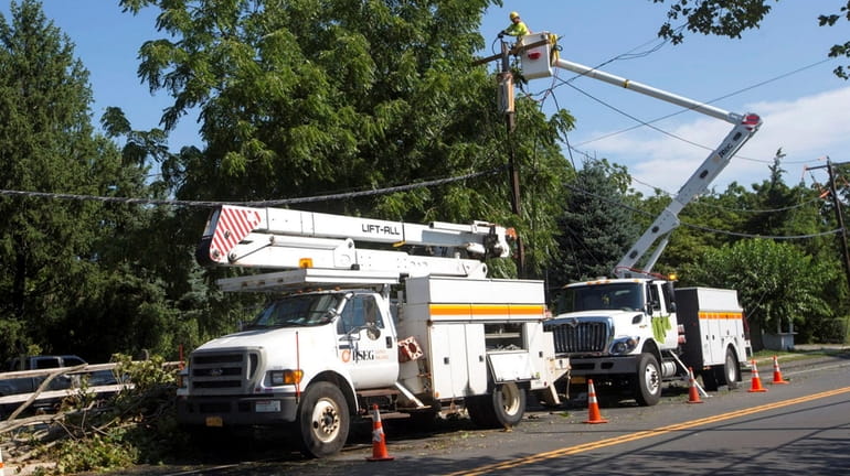PSEG Long Island crew work on a utility pole on...