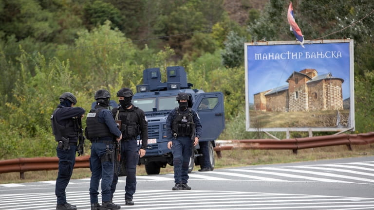 Kosovo police officers stand on the road near Banjska Monastery...