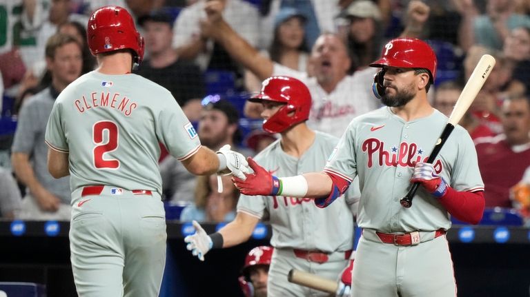 Philadelphia Phillies' Kody Clemens (2) is met by Kyle Schwarber,...