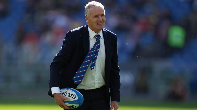 Italy head coach Kieran Crowley holds a ball during the...