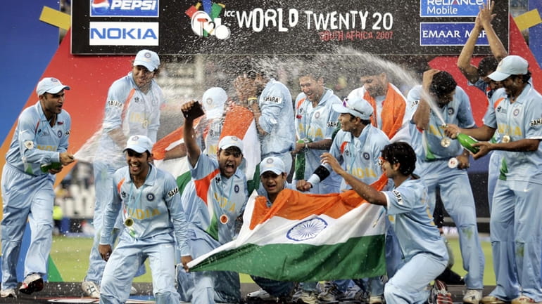 Indian cricket players celebrate after beating Pakistan during the final...