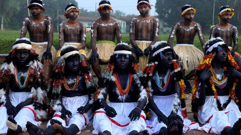 Indigenous girls and boys prepare to take part of a...