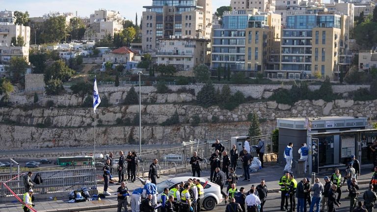 Israeli police officer and volunteers from the Zaka rescue service...