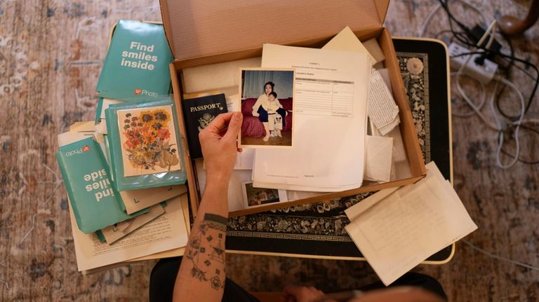 Robert Calabretta holds a picture of his biological mother and...