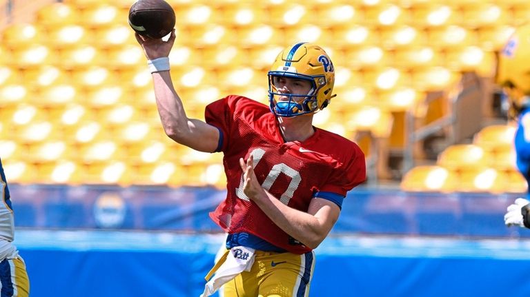 Pittsburgh quarterback Eli Holstein drops back to pass during the...