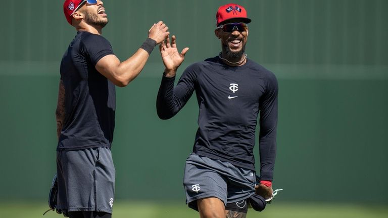 Minnesota Twins shortstop Carlos Correa, left, and Minnesota Twins designated...