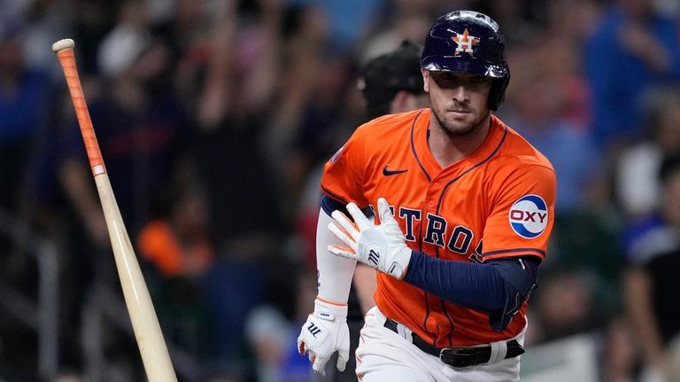 Houston Astros' Alex Bregman flips his bat after hitting a...