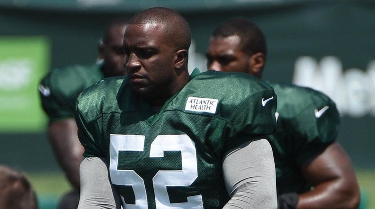 New York Jets inside linebacker David Harris stretches during training...