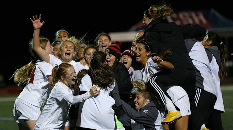 Syosset celebrates its victory against East Meadow in the Nassau girls soccer...