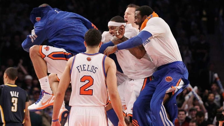The Knicks celebrate after a three-point basket by Steve Novak...