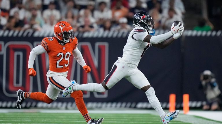 Houston Texans wide receiver Stefon Diggs, right, catches a pass...