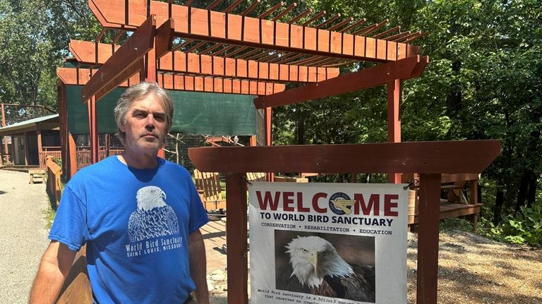 World Bird Sanctuary Executive Director Roger Holloway stands next to...