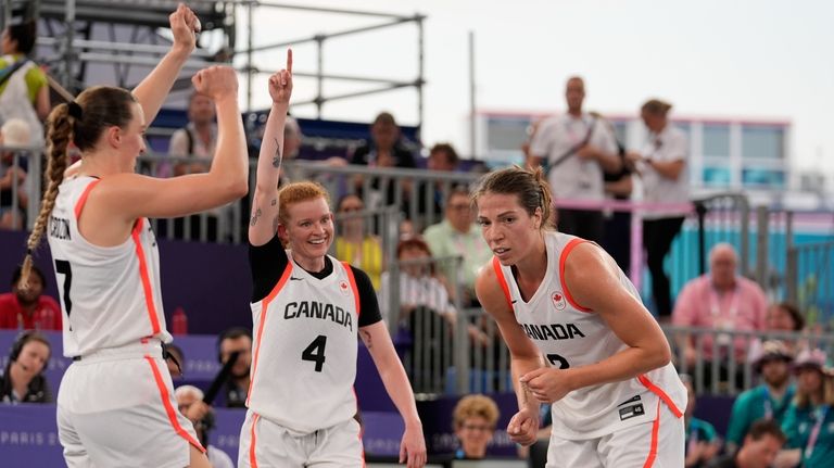 Canada's Kacie Bosch, center, celebrates her teams win with Paige...