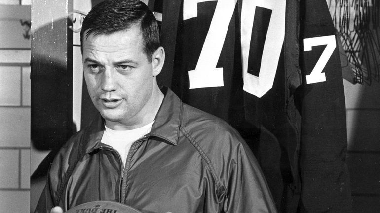 Washington's Sam Huff poses in front of his jersey in...