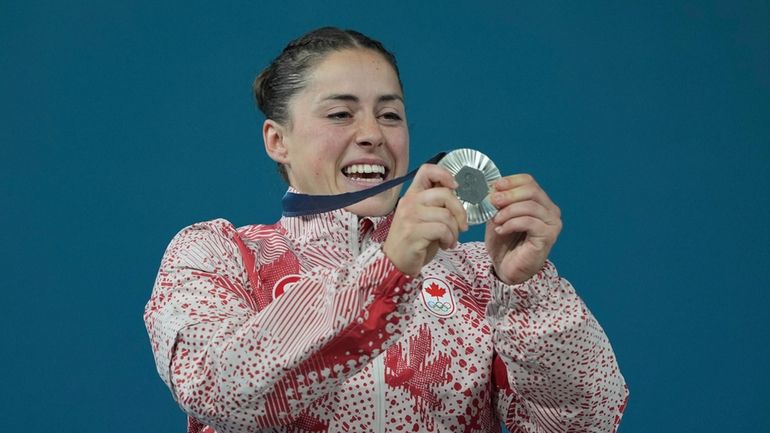 Silver medalist Maude Charron of Canada celebrates on the podium...