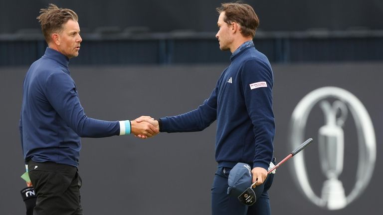 Henrik Stenson, left, shakes hands with Rasmus Højgaard of Denmark...