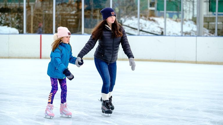 Maeve Garvey and Olivia Garvey skate at the Christopher Morley...