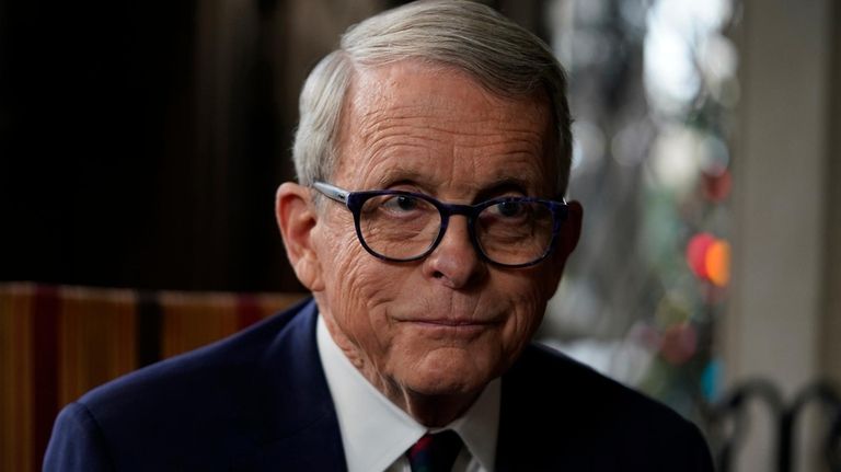 Ohio Gov. Mike DeWine pauses as he speaks during an...